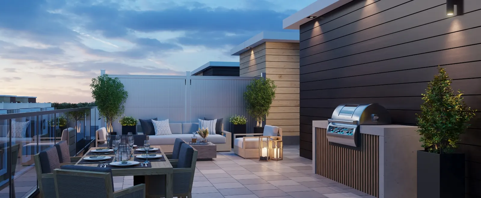 Private rooftop terrace on a Qui Club town at dusk — dining table, lounge seating, planters and a built-in barbecue.